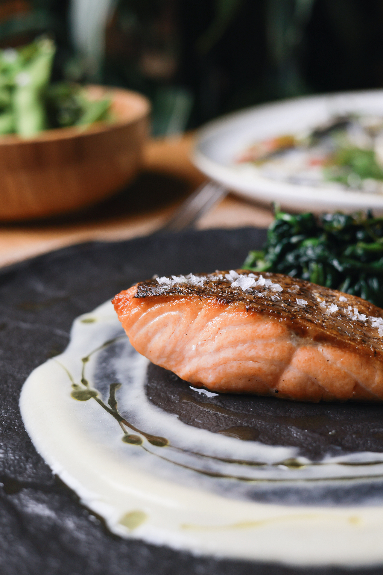 Pan-seared salmon with crispy skin, sea salt and greens at Ujvara