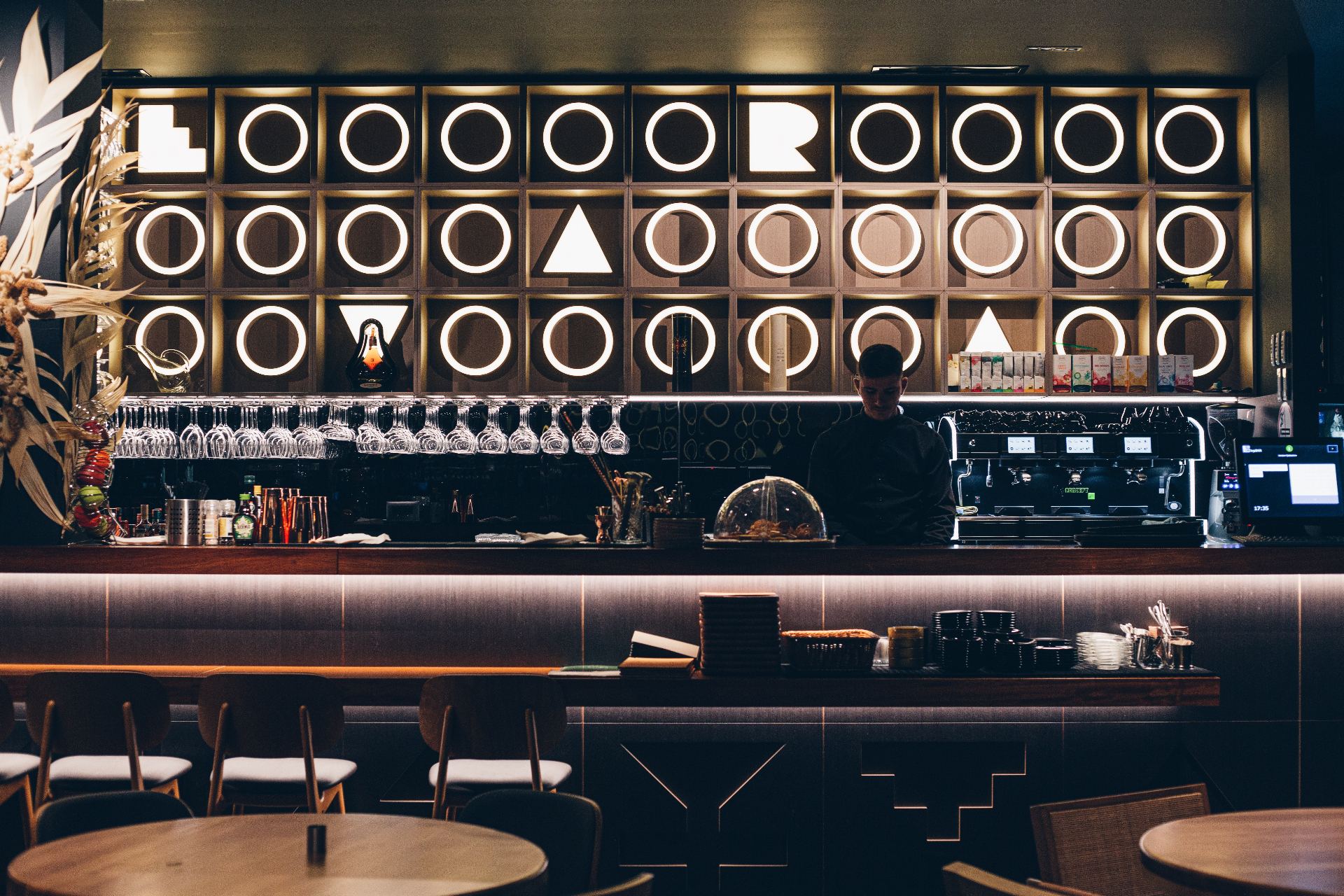 Ujvara bar interior with illuminated geometric back wall